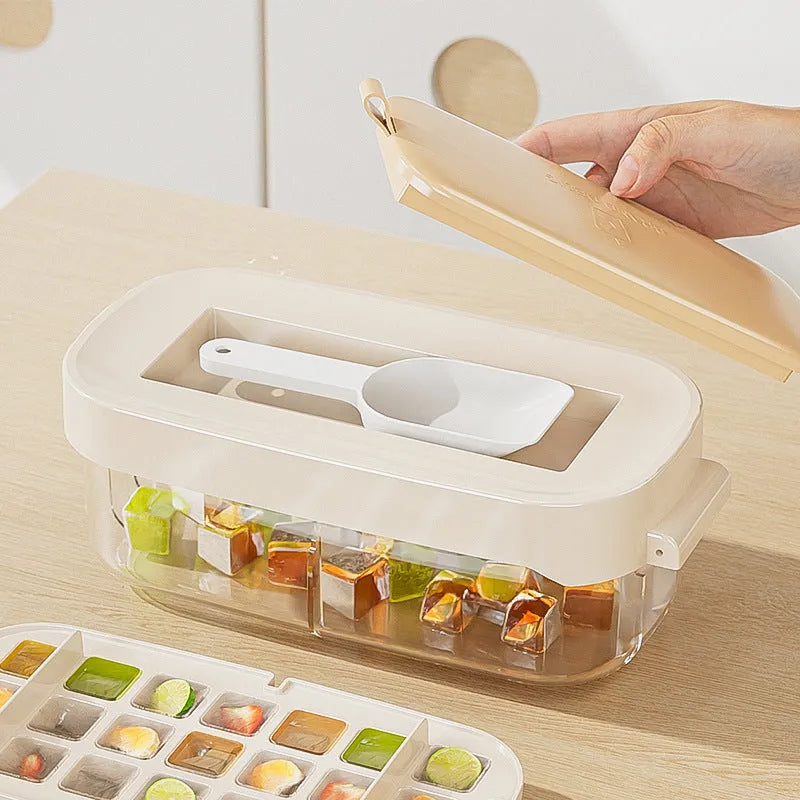 Yellow high-capacity silicone ice cube tray with lid, showing the grid of 1 cm cubes and the ice shovel stored in its slot.