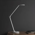 ProLED folding desk lamp with adjustable arm and intelligent eye protection features on a wooden desk