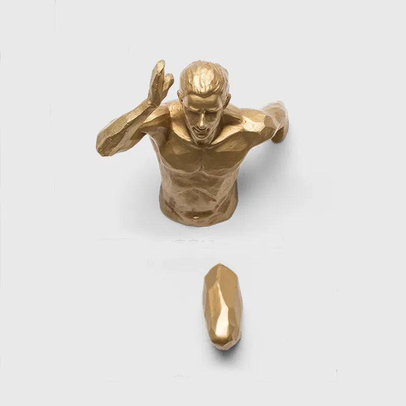 Resin character wall hanging decoration in metallic finish on a plain wall