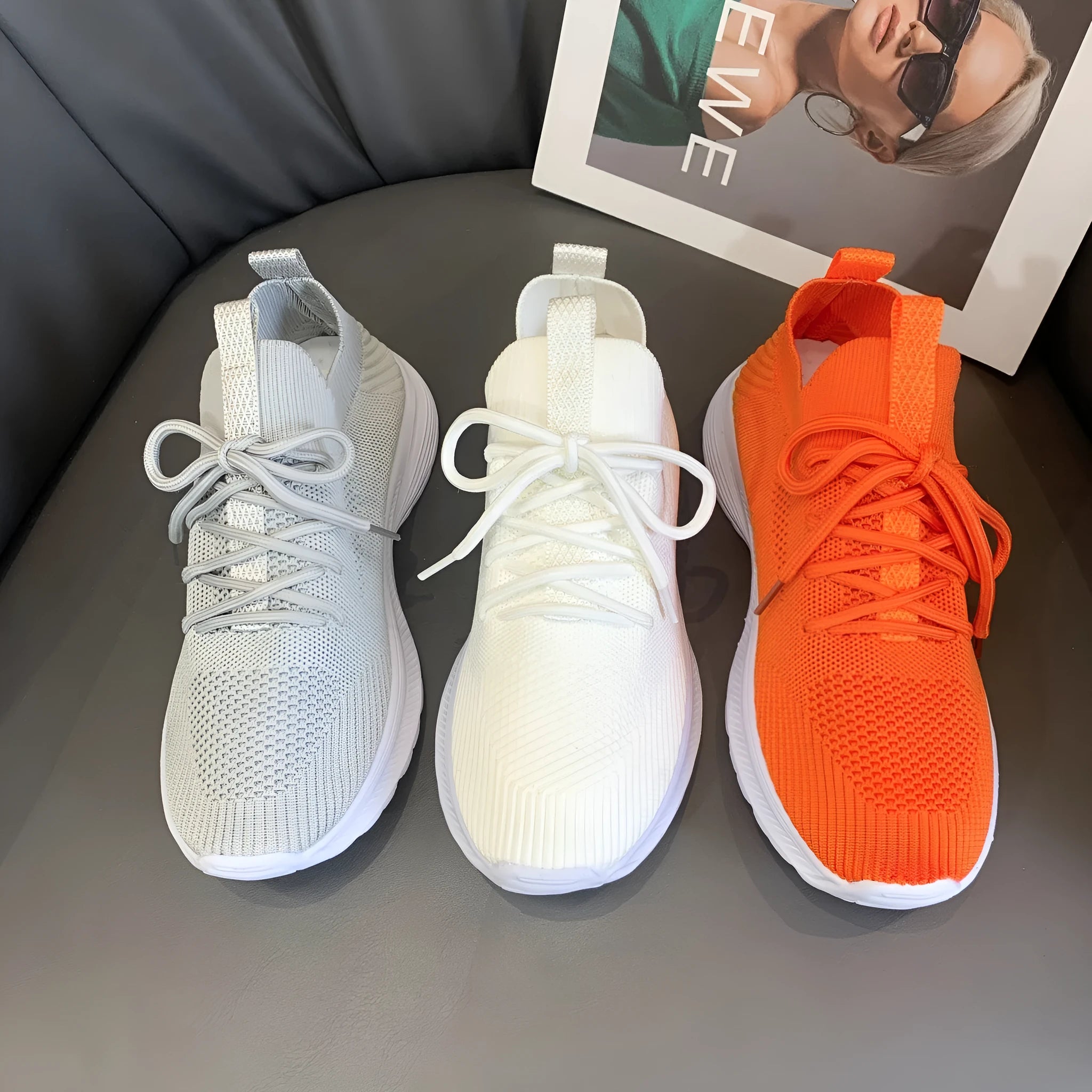 Women's low-top mesh running shoes in creamy white with a flat rubber sole and distinctive English muffin heel detail.