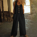 Sleeveless wide leg cotton jumpsuit in peacock green with side pockets and loose trousers.