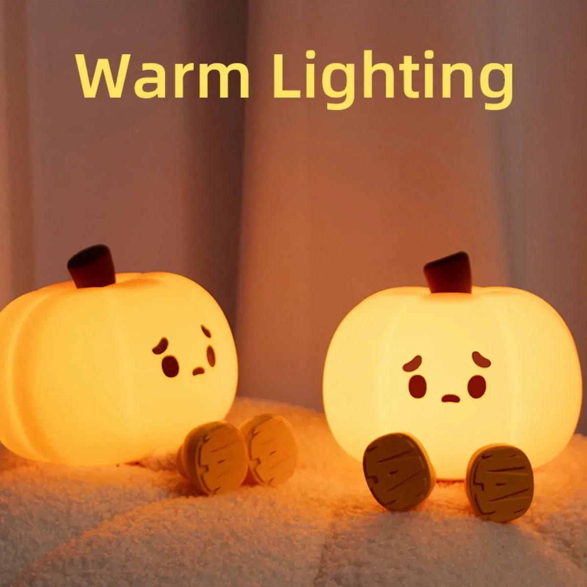 Pumpkin-shaped silicone night light with rechargeable battery on a bedside table