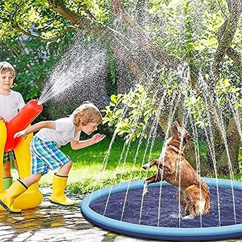 Dog playing on a large blue anti-slip splash pad mat in a garden, with water sprinklers active.