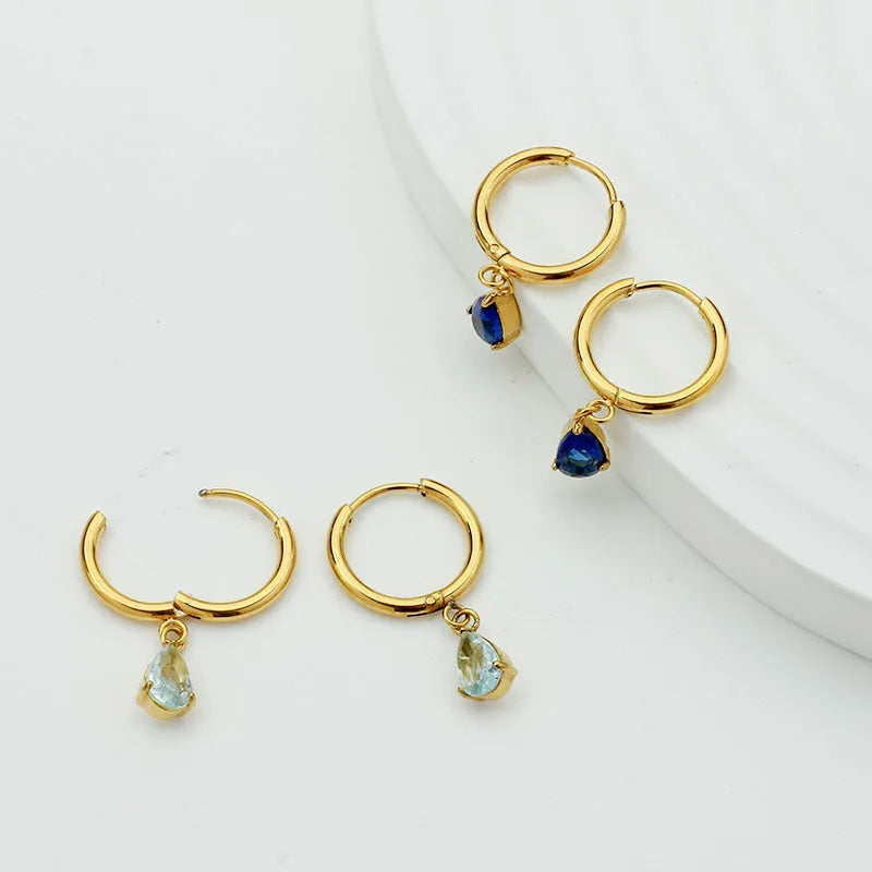 Drop-shaped zircon earrings in seven colours on a woman's earlobe titanium steel geometric design