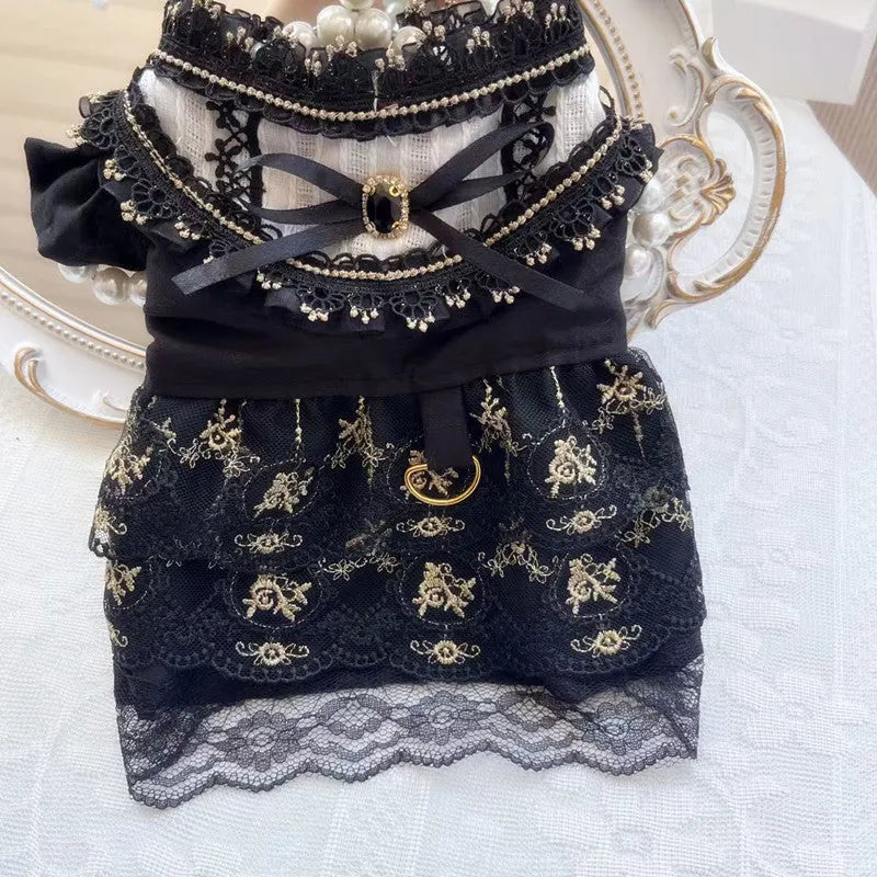 Golden gothic-style layered skirt for a small dog or cat on a mannequin, showing adjustable velvet collar.