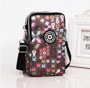 Vertical Oxford cloth phone bag with zip, key loop inside, showing floral and cartoon rabbit print options.