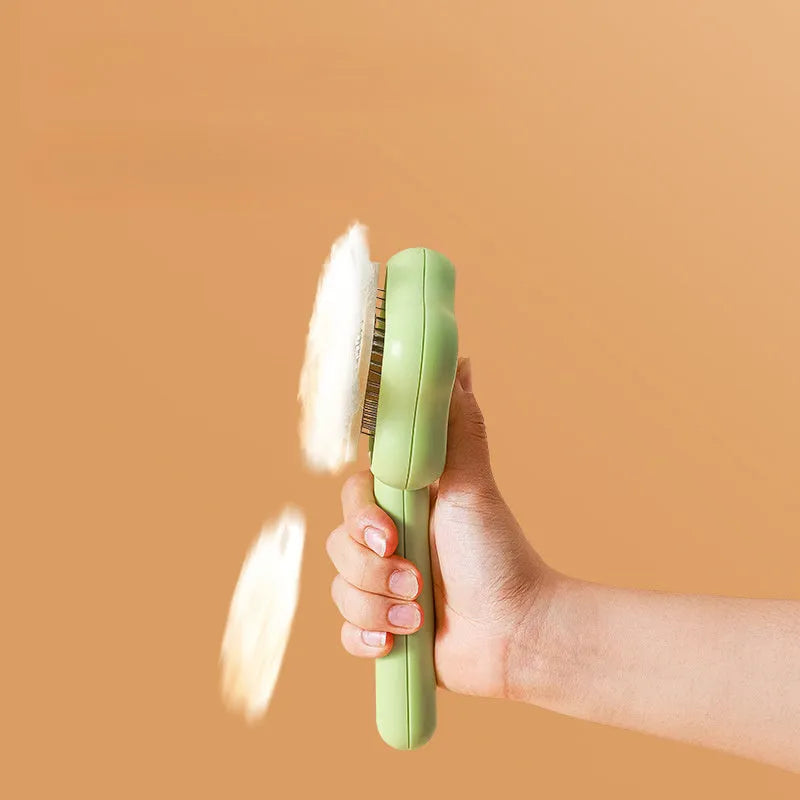 Green and yellow handled self-cleaning pet grooming comb with stainless steel needle bristles.