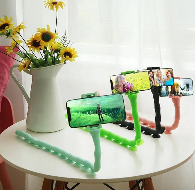 Flexible rubber phone holder with suction cup wrapped around bicycle handlebar