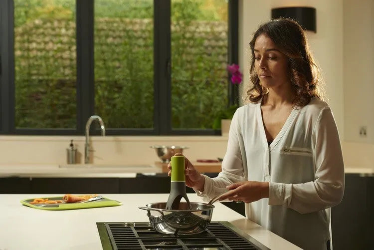 Green automatic cooking mixer device for stirring sauces and soups in pot