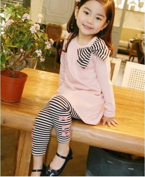 Pink cotton two-piece clothing set for a girl, showing the matching top and bottom.