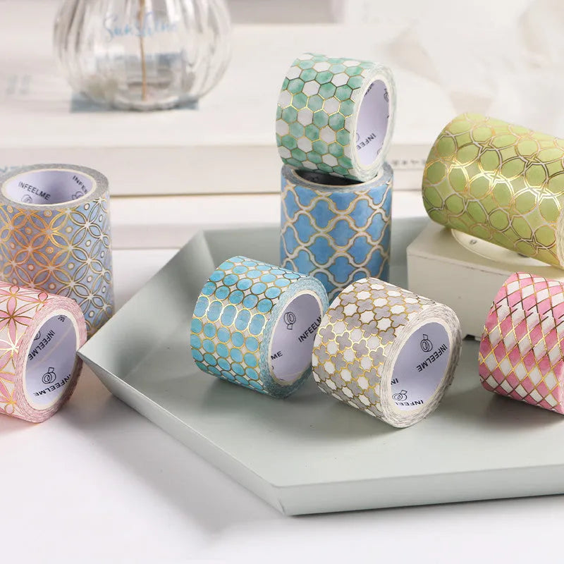 Roll of bronzing and paper decorative tape in gold colour, showing metallic finish.