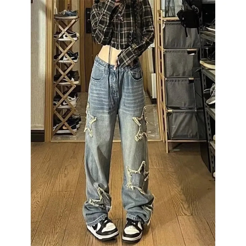 Blue high-waisted women's wide-leg denim jeans on a model, showing the straight-leg cut.