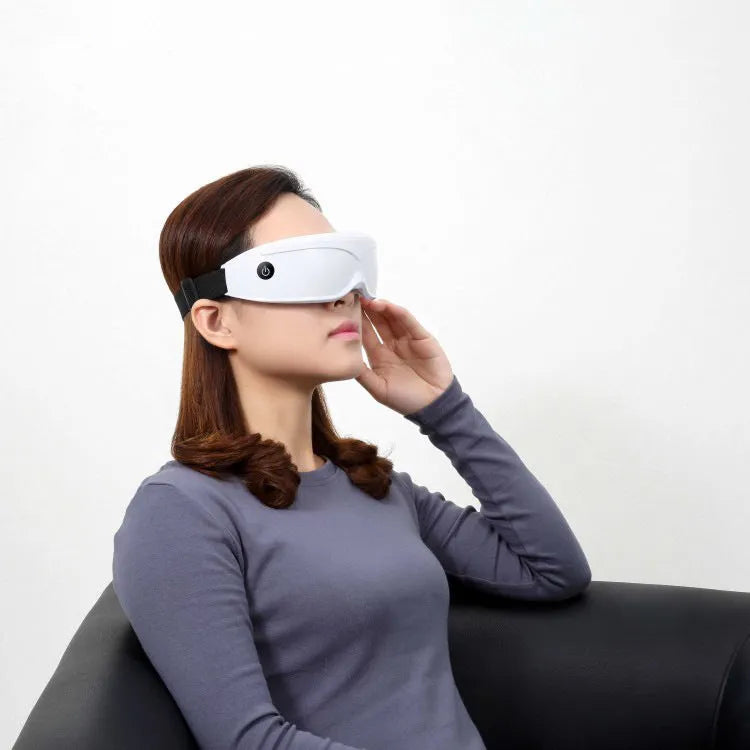 Eye massager with adjustable headband, silicone contacts, and 9 vibration modes in black and white colour