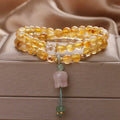 Women's crystal bracelet with natural gold rutilated quartz yellow tower double ring Lily pendant, pearl and rhinestone accents, 34cm length