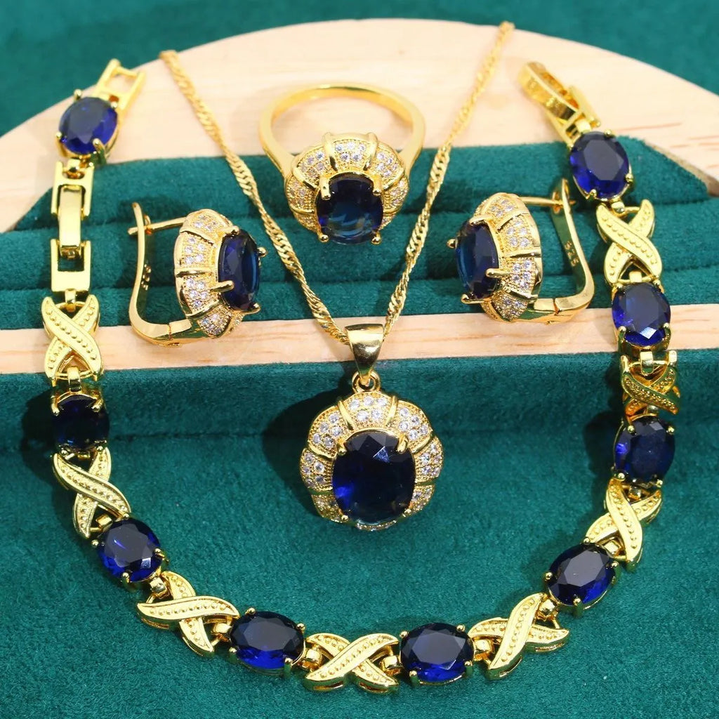 Gold-plated jewellery set with multi-colour zircon stones including necklace, earrings, ring, and bracelet.