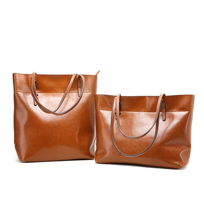 Brown waxed cowhide crossbody handbag showing front flap and adjustable strap against a neutral background.