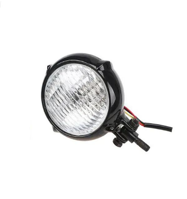 Black retro Harley-style halogen headlight unit with an aluminium housing and yellow lens.
