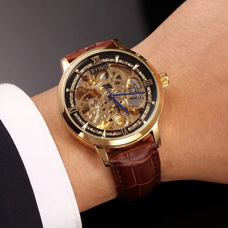 Men's automatic mechanical watch with hollow skeleton dial, leather strap, gold-tone casual design, waterproof