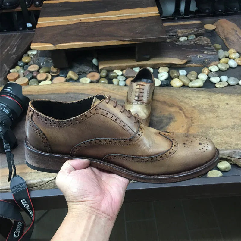 Light brown men's vintage distressed leather lace-up shoes with carved detailing on the upper.
