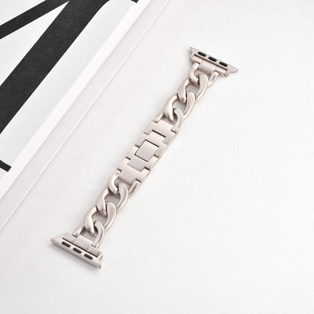 Metal denim chain Apple Watch strap in silver, black, gold, rose gold, and Starlight colours showing textured design
