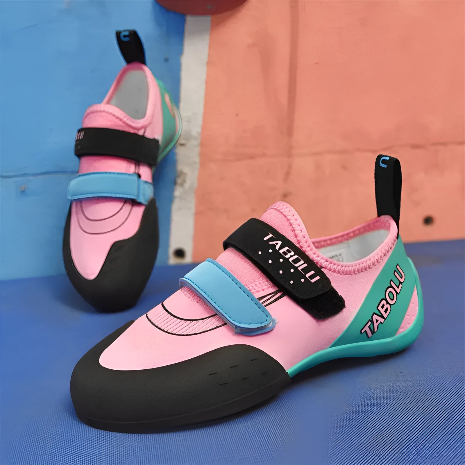 Beginner rock climbing shoes with Velcro strap in black and red colourway.