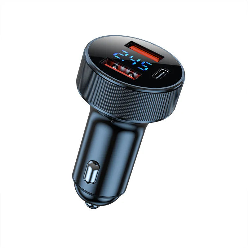 Black aluminium alloy car charger with digital display and three USB ports plugged into a vehicle socket.
