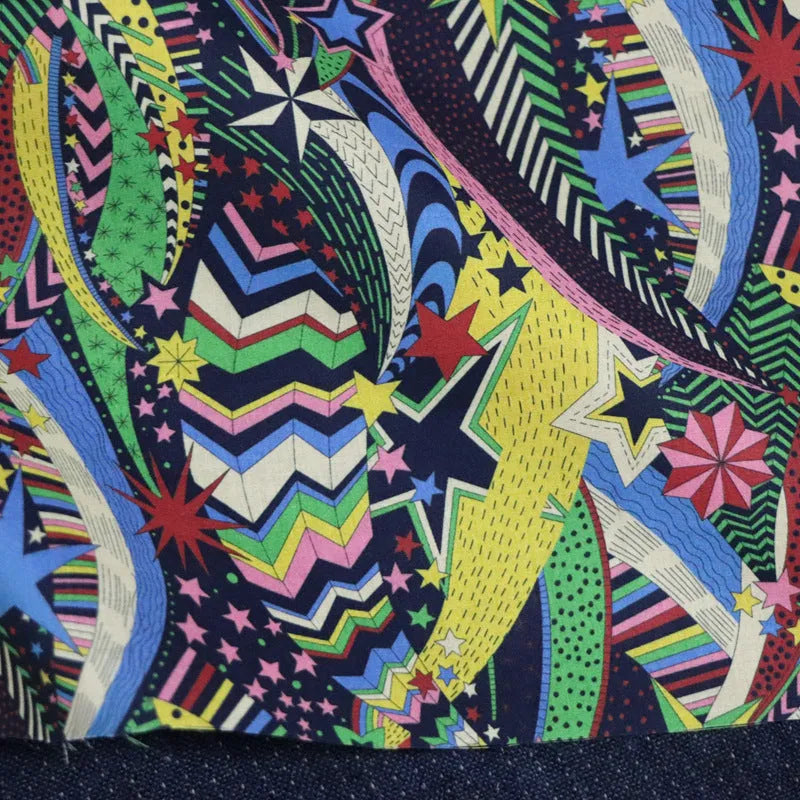 Blue plant and flower pattern on 100% cotton fabric, showing the 145 cm width.