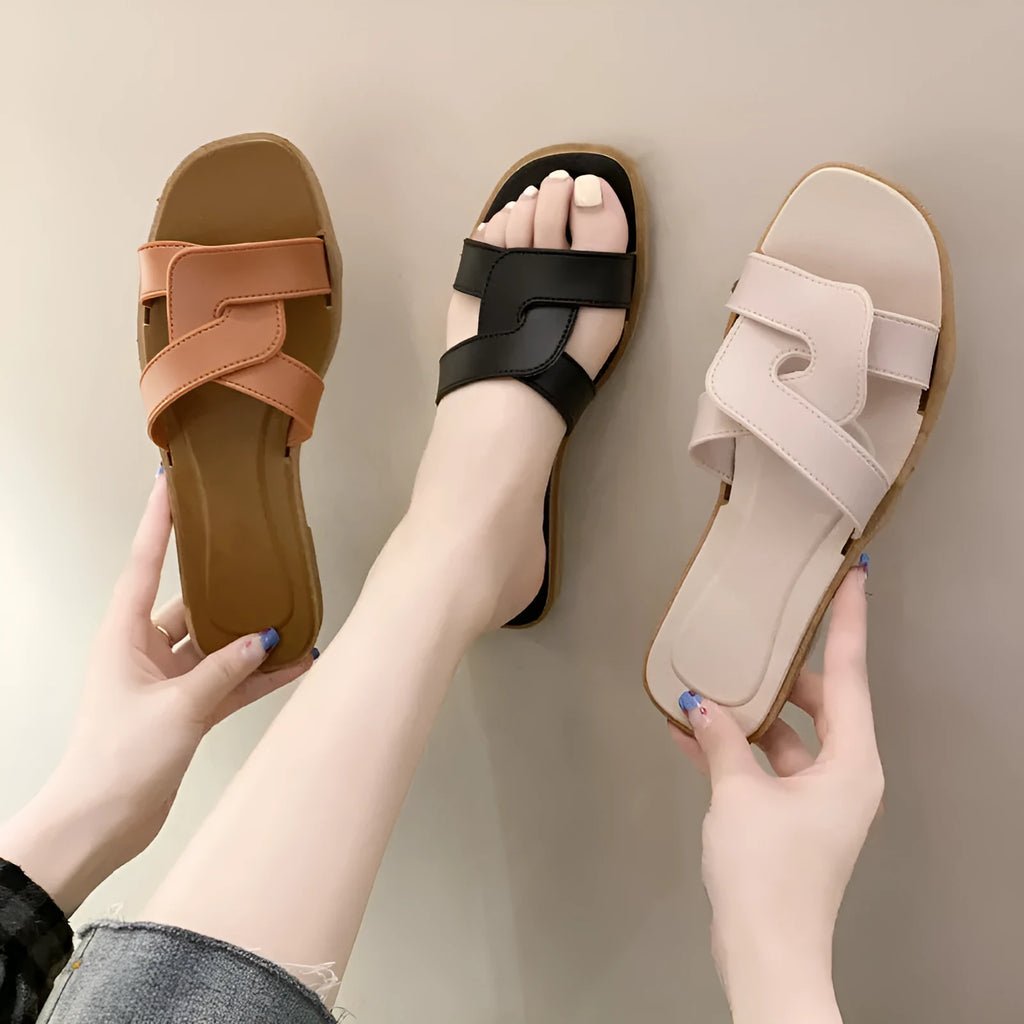 Women's cross strap PVC sandals in light blue, showing toe ring and non-slip sole.