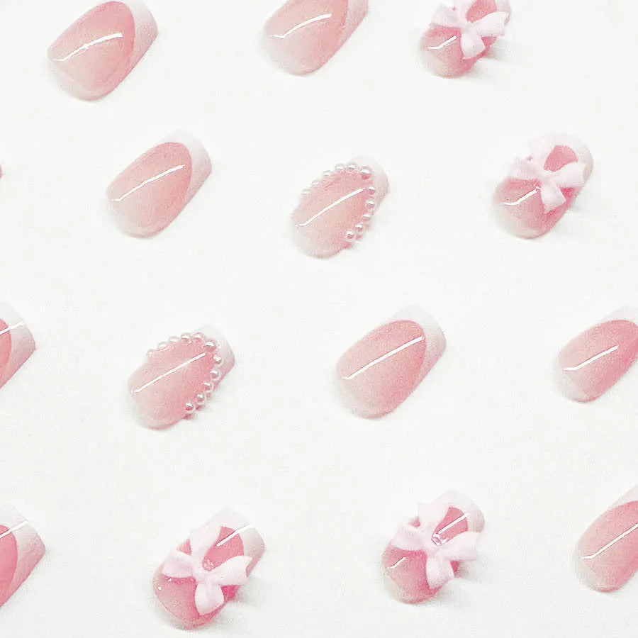Set of 24 short French manicure false nails with white tips, bow designs, tulip patterns, and leopard print on a European square shape.