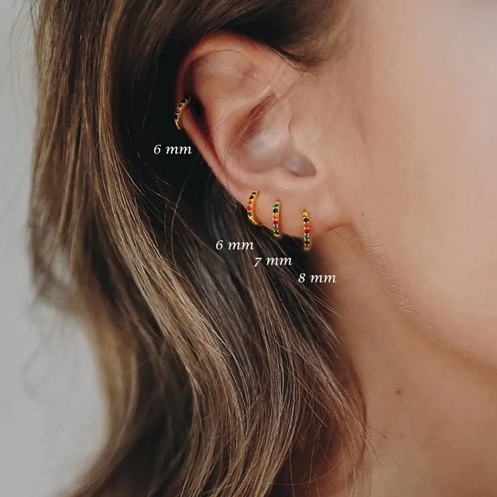Gold, rose gold, and silver coloured perforated circle zircon stud earrings in various sizes from 5mm to 12mm diameter.