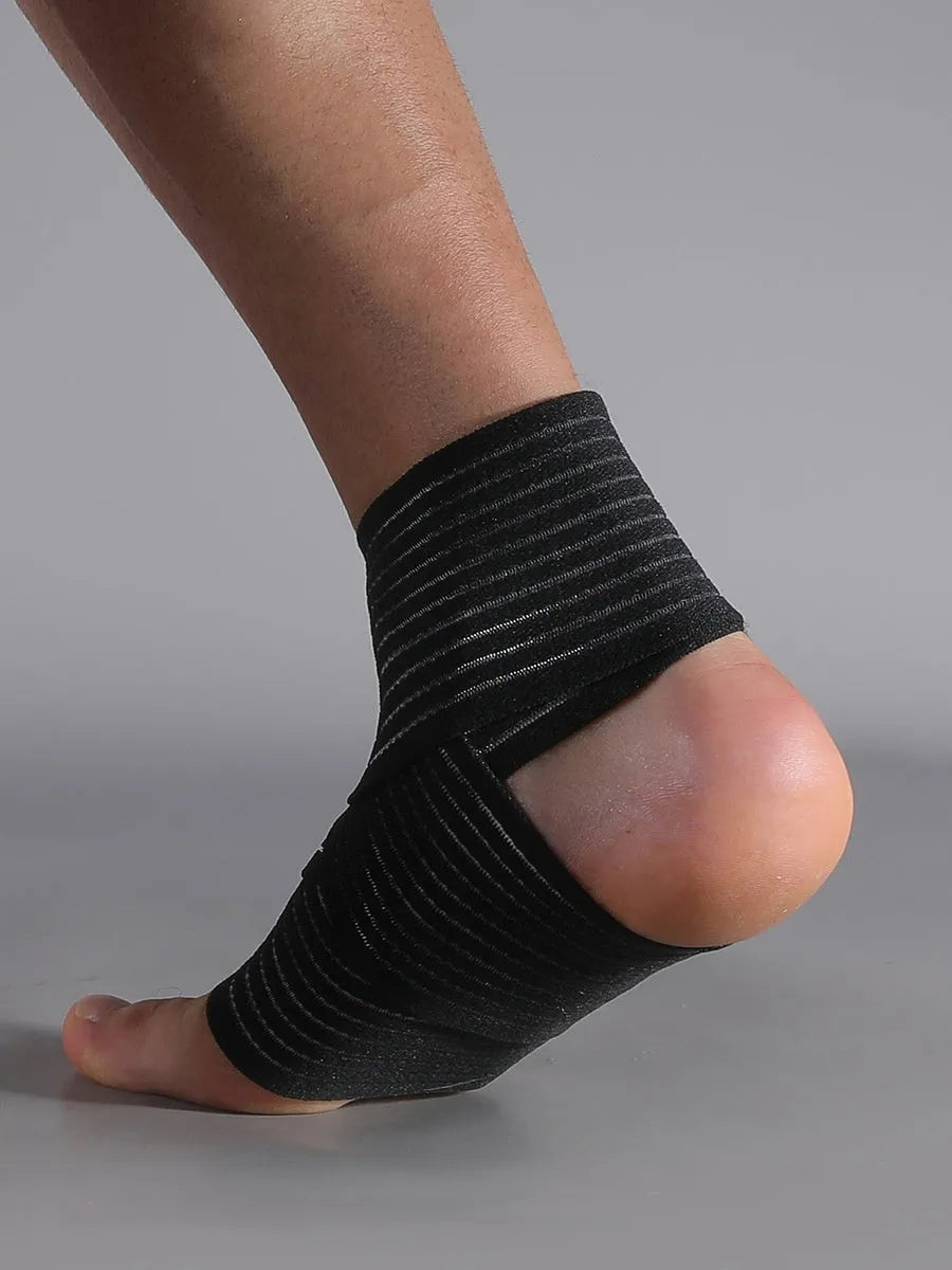 Black adjustable sports ankle support bandage wrapped around a joint