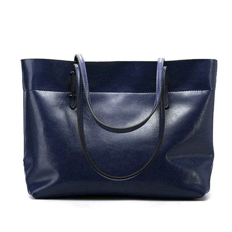 Brown waxed cowhide crossbody handbag showing front flap and adjustable strap against a neutral background.