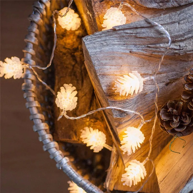Warm white battery-operated LED pine cone string lights for decoration, showing plastic shell design.