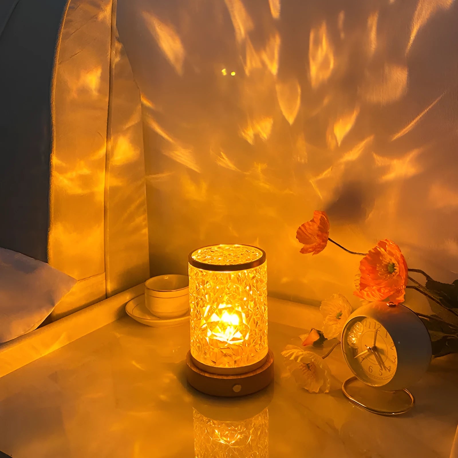 Small rotating water ripple night light with an acrylic shade on a solid wood base.