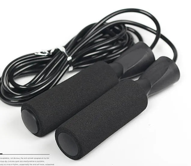 Adjustable Jump Fit Rope with black weighted handles and red speed rope on a dark workout mat