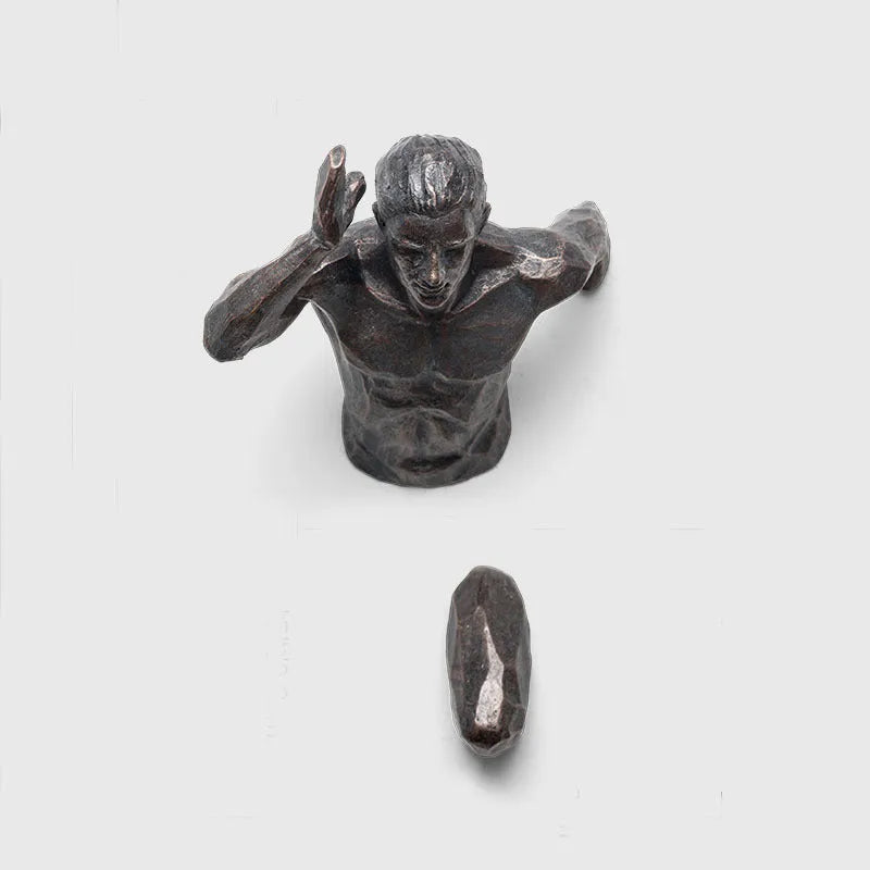 Resin character wall hanging decoration in metallic finish on a plain wall