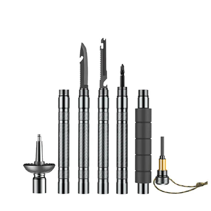 Dark grey aluminium trekking pole with tactical knife and screwdriver accessories on a hiking trail