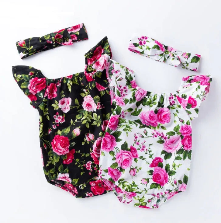 White baby girl's sleeveless cotton romper with small flying sleeves on a hanger.