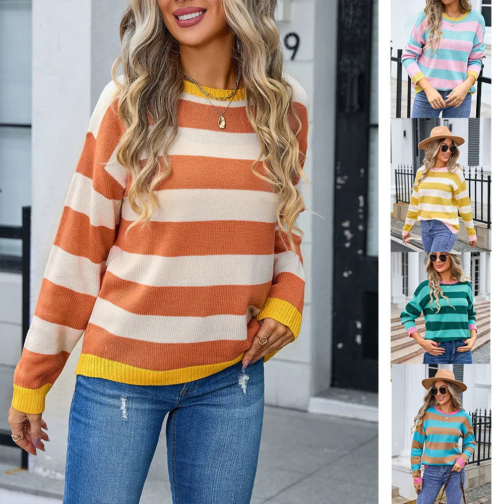 Loose fit blue women's acrylic sweater with round neck and long sleeves laid flat.