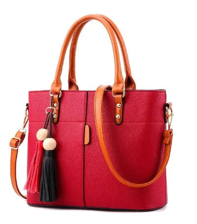Women's PU leather crossbody shoulder bag in Black with silver-tone clasp, worn over shoulder
