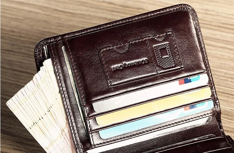 Men's black full-grain leather bifold wallet open, showing card slots, note pocket, and zipped coin compartment.