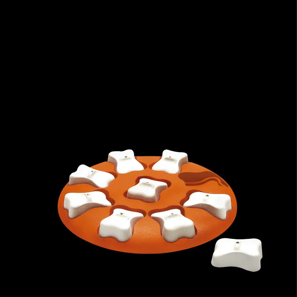 Orange and white plastic leak food puzzle toy for dogs and cats with kibble falling from opening