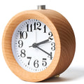 Solid beech wood analogue alarm clock with silent snooze on wooden surface