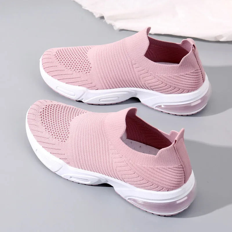 A pair of low-top slip-on sock shoes in a choice of colours, showing the mesh lining and lightweight PVC sole.