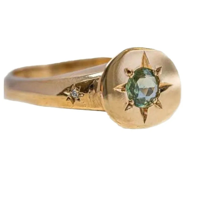 Gold coloured adjustable ring with oval star shape and central asterism zircon stone.
