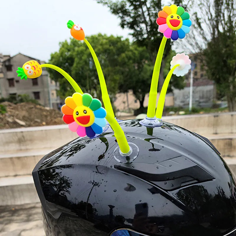 Yellow silicone sunflower decoration with a clear suction cup for helmet attachment.