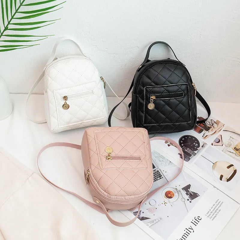 Girls' hard structured backpack with embroidery in white, black, or pink colours, showing front view and soft handle.