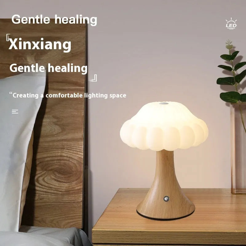 Small mushroom-shaped touch sensor night light showing USB charging port and woodgrain colour finish.