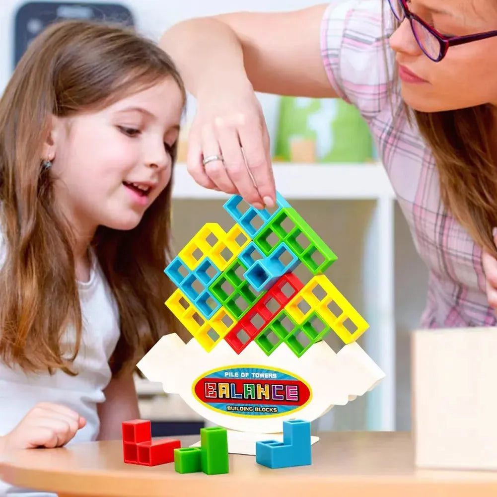 Plastic balance stacking board game with 16 coloured blocks, chassis, and base on a 26.5cm square box.