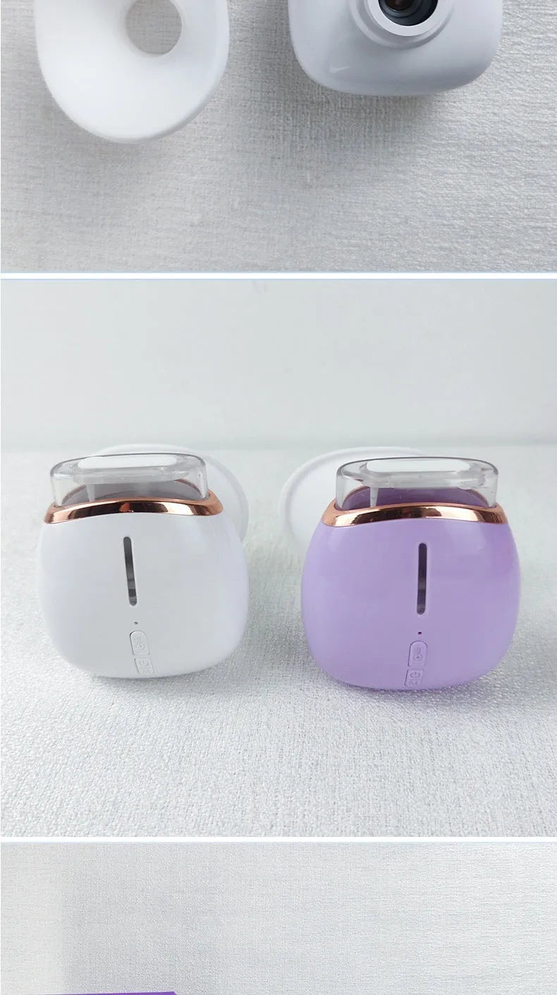 White and purple household eye humidifier device with USB charging cable on plain background
